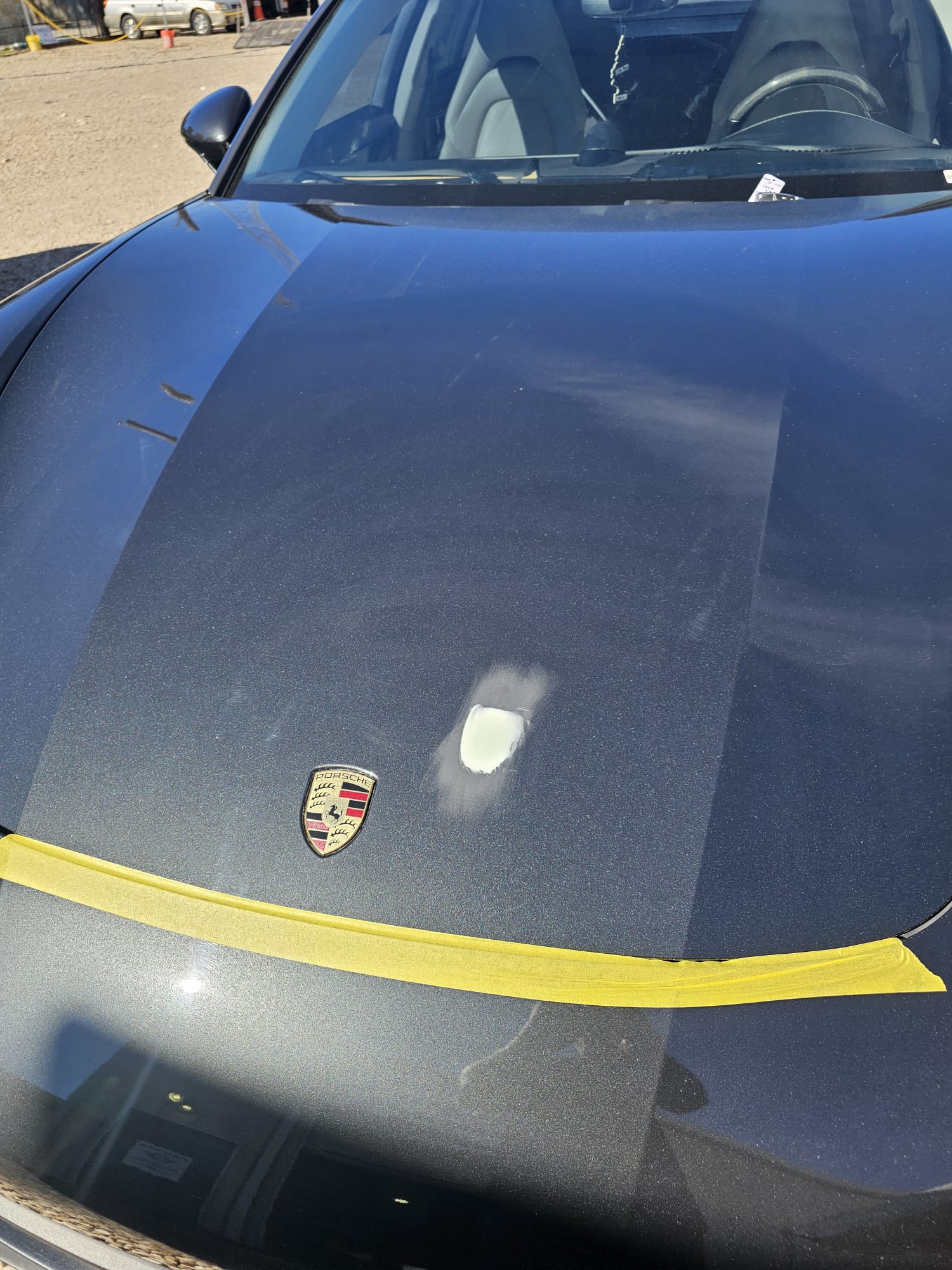 Micro paint repair specialist at work on a Porsche